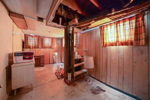 Basement featuring wood walls