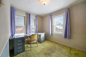 Carpeted office space with plenty of natural light