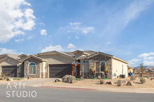 View of front of property featuring a garage and cooling unit