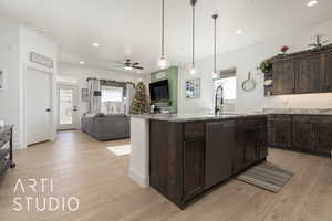 Kitchen with light wood-type flooring, dark brown cabinetry, ceiling fan, sink, and dishwasher