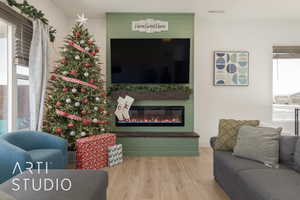 Living room with a large fireplace and wood-type flooring