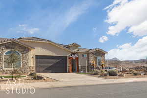 View of front of property with a mountain view and a garage