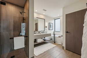 Bathroom featuring separate shower and tub, a wealth of natural light, tile patterned flooring, and vanity