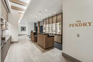 Kitchen featuring a kitchen bar, kitchen peninsula, and light tile patterned floors