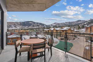 Snow covered back of property featuring a mountain view