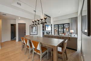 Dining space with light hardwood / wood-style floors