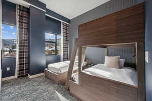 Bedroom with a mountain view and carpet flooring