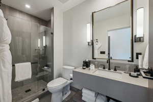 Bathroom with walk in shower, hardwood / wood-style floors, vanity, and toilet