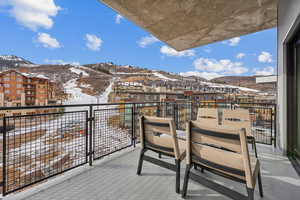 Snow covered back of property with a mountain view