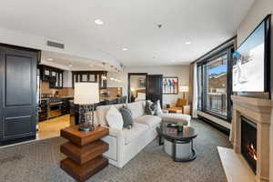 Tiled living room featuring an inviting chandelier