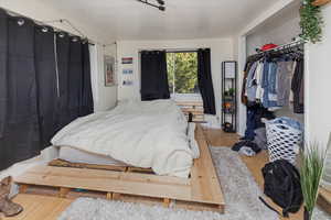 Bedroom featuring hardwood / wood-style flooring and a closet