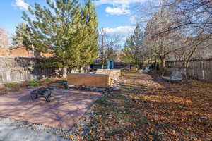 View of yard featuring a patio and a fire pit