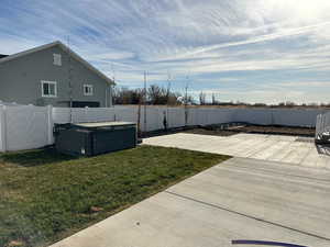 View of yard with a patio and a hot tub