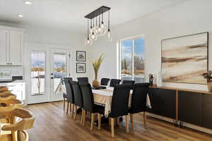 Dining room with french doors and light hardwood / wood-style flooring