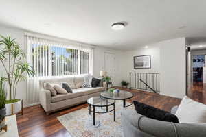 Living room with dark wood-type flooring