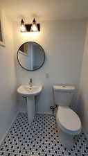 Bathroom with sink, tile patterned flooring, and toilet