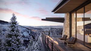 Snow covered back of property with a mountain view