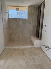 Bathroom featuring tiled shower