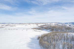 Snowy aerial view featuring a mountain view