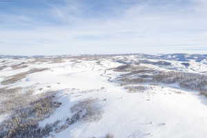 Snowy aerial view featuring a mountain view