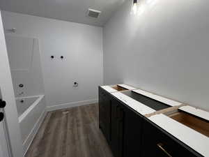 Main Bathroom featuring a bath and hardwood / wood-style flooring