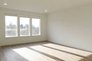 Empty room with light hardwood / wood-style floors