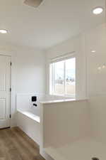 Bathroom featuring a washtub and hardwood / wood-style flooring