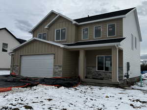 View of front of house featuring a 4 car garage