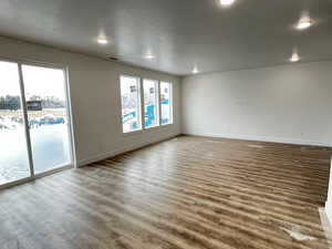 Dining room/ Great room with wood-type flooring and a textured ceiling