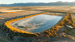 Drone / aerial view with a water and mountain view