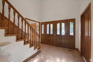 Foyer entrance featuring a high ceiling