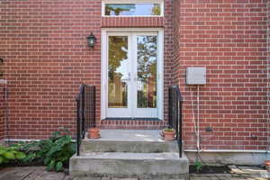 Property entrance featuring french doors