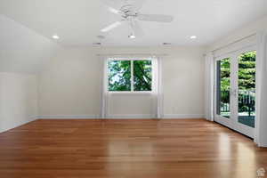 Bonus room with lofted ceiling, french doors, and light hardwood / wood-style flooring