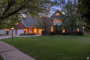 View of front of house with a yard and a garage