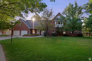 View of front of house with a lawn and a garage