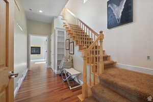 Stairway featuring hardwood / wood-style floors