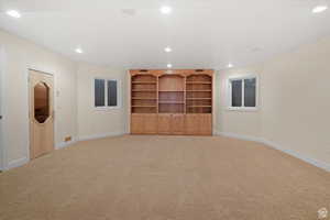 Unfurnished living room featuring light carpet