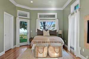 Bedroom featuring access to outside, light hardwood / wood-style floors, and ornamental molding