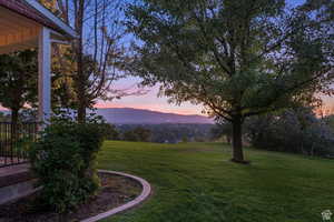 Yard at dusk featuring a mountain view