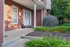 View of exterior entry with covered porch