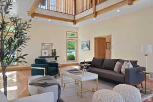 Living room with wood-type flooring and a high ceiling