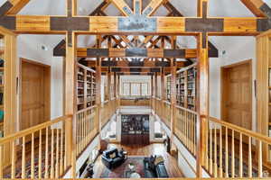 Wine cellar with lofted ceiling with beams and hardwood / wood-style flooring