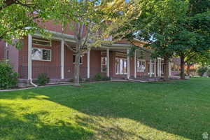 View of front of property with a porch and a front yard