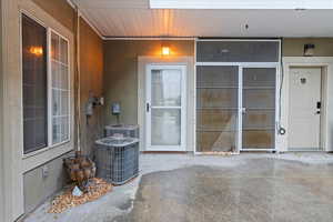 Entrance to property featuring central AC unit