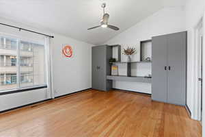 Interior space featuring ceiling fan, light hardwood / wood-style flooring, and lofted ceiling