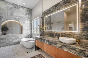 Bathroom featuring vanity, tile walls, and independent shower and bath