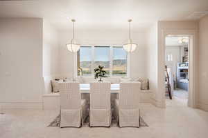 Carpeted dining room featuring a mountain view