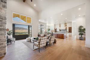 Living room with a mountain view, high vaulted ceiling, and light wood-type flooring