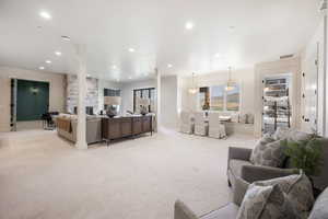 Carpeted living room with a stone fireplace