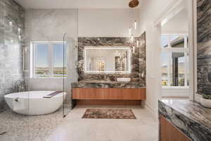 Bathroom featuring a bathing tub, vanity, a mountain view, and tile walls